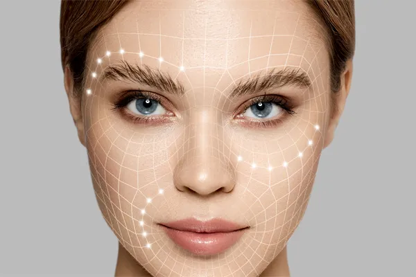 Aesthetic-Fillers-Doctor Close-up of a beautiful face against a gray background, with flowing gridlines illustrated along the cheeks, brow and lips, representing aesthetic filler services from Tanya Zboril, NP of TBT Medical in Kitchener-Waterloo.