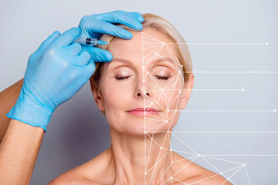 Aesthetic-Injectables-Clinic A mature blonde woman gets a facial injection. Get injectable aesthetic treatments from Tanya Zboril, NP of TBT Medical in Kitchener-Waterloo.