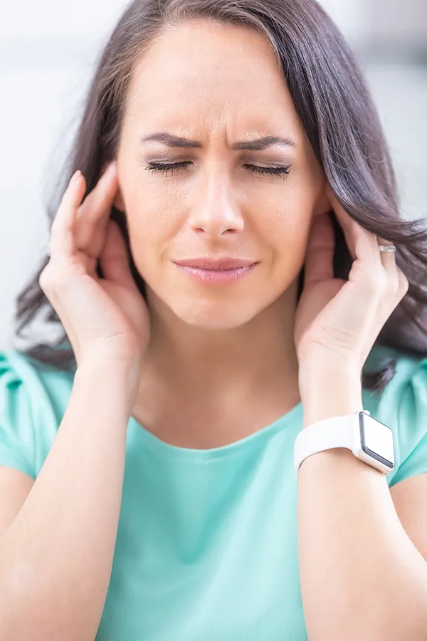 Botox-for-Migraines-Treatment A woman suffering from a migraine rubs her temples. Get Botox for migraines from Tanya Zboril, NP of TBT Medical in Kitchener-Waterloo.