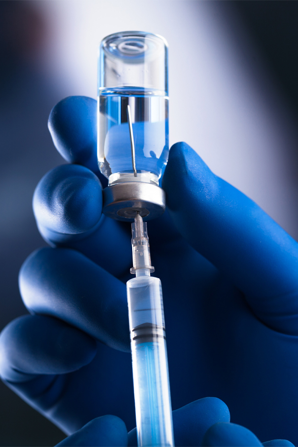 Chin-Fat-Reduction-Treatment Close-up of a hand in a surgical glove drawing fluid from a vial into a syringe. Get chin fat reduction treatment from Tanya Zboril, NP of TBT Medical in Kitchener-Waterloo.