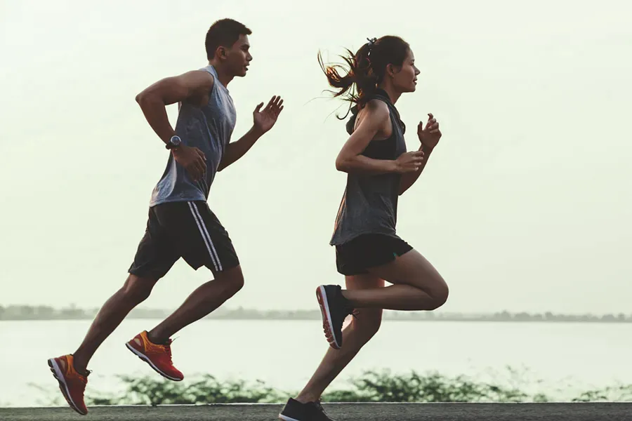 GLP-1-Weight-Loss-Injections-Clinic A couple in profile running along the water. Schedule GLP-1 Weight Loss Injections from Tanya Zboril, NP of TBT Medical in Kitchener-Waterloo.