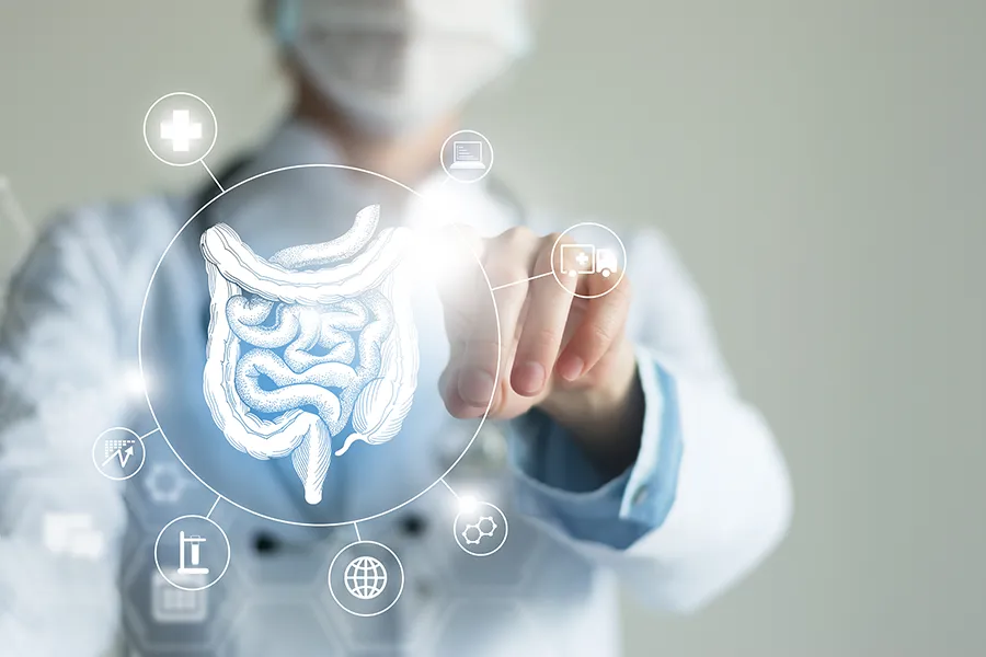 Leaky-Gut-Syndrome-Clinic Tanya Zboril, NP of TBT Medical provides advanced Functional Medicine for Leaky Gut Syndrome treatments in Kitchener-Waterloo, shown by a doctor touching a glowing digital intestinal health display.