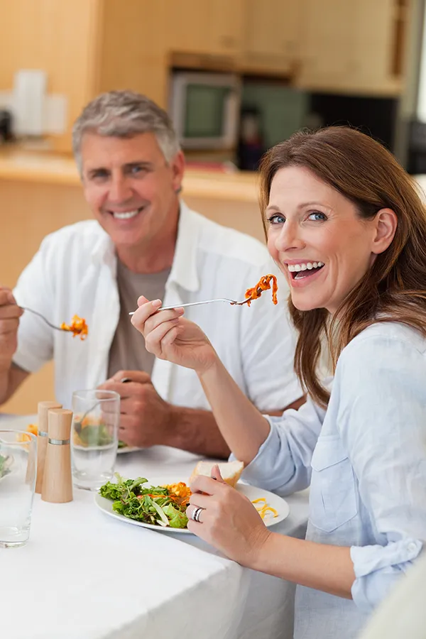Leaky-Gut-Syndrome-Treatment Improve digestion with Tanya Zboril, NP of TBT Medical's Functional Medicine for Leaky Gut Syndrome care in Kitchener-Waterloo, featuring a happy couple enjoying a nutritious lunch at home.