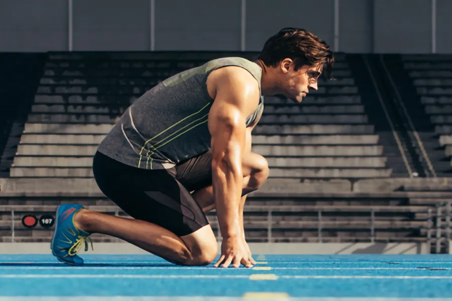 Lean-Muscle-and-Recovery-Clinic A white man kneels at the starting line on a track, determined to do his best. Get treatment for lean muscle loss and recovery from Tanya Zboril, NP of TBT Medical in Kitchener-Waterloo.