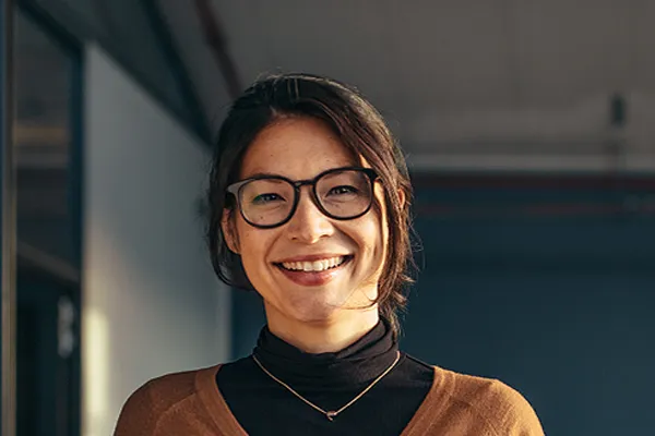 Metabolic-Syndrome-Clinic A brunette woman with glasses smiles in a gray-blue walled office. Get metabolic syndrome from Tanya Zboril, NP of TBT Medical in Kitchener-Waterloo.