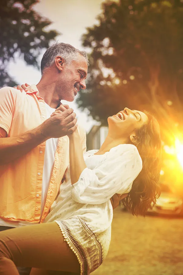 Metformin-Weight-Loss-Treatment A middle-aged couple dances playfully in the woods at sunset. Get Metformin for weight loss treatment from Tanya Zboril, NP of TBT Medical in Kitchener-Waterloo