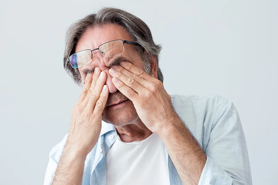Migraine-Clinic Get migraine relief with Tanya Zboril, NP of TBT Medical's functional medicine for migraines treatment in Kitchener-Waterloo, represented by an older man rubbing his eyes due to head pain.