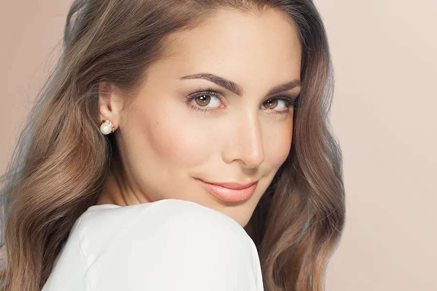 Nuceiva-Facial-Injections-Clinic A woman with long brown hair and radiant skin. Get Nuceiva® facial injections from Tanya Zboril, NP of TBT Medical in Kitchener-Waterloo.