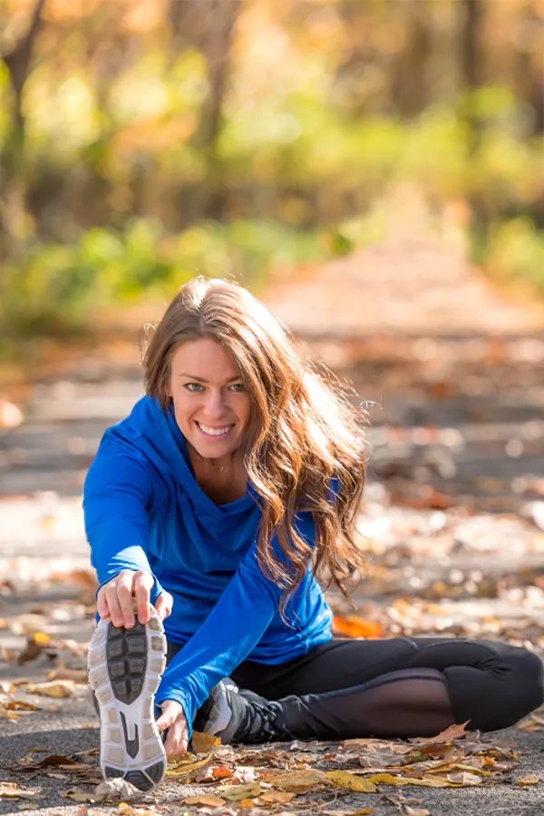 Sermorelin-Treatment A healthy woman in blue sweats stretches on a trail before a run. Get Sermorelin peptide therapy from Tanya Zboril, NP of TBT Medical in Kitchener-Waterloo.