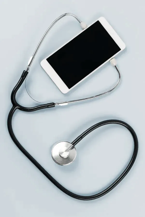 Telemedicine-Treatment A smartphone with a stethoscope attached to it, symbolizing Telemedicine treatment from Tanya Zboril, NP of TBT Medical in Kitchener-Waterloo.