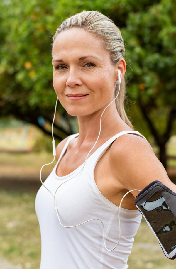fibromyalgia-doctor Middle-aged, active woman taking a break to smile at the camera during a run, representing successful Bioidentical Hormones for Fibromyalgia Relief offered by Tanya Zboril, NP of TBT Medical in Kitchener-Waterloo.